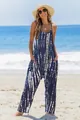 Bohemian blue tie-dye sleeveless jumpsuit with pockets for women on a sunny summer beach. - Blue