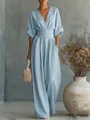 Model wearing an elegant light blue V-neck jumpsuit with a cinched waist and wide legs - S / Top And Bottom / Sky Blue