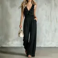 Elegante zwarte mouwloze jumpsuit met ruches in de V-hals en wijde pijpen silhouet - S / Top And Bottom / Zwart