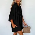 Side view of a casual loose black summer romper with button collar and side pockets - S / Top And Bottom / Black