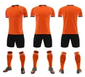 Multiple views of breathable orange and black soccer jersey set with shorts and socks - 3XS / Top And Bottom / Orange