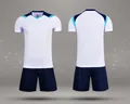 Detailed front and back views of white and navy blue dry-fit soccer training kit - 4XS / Top And Bottom / White