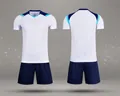 Detailed front and back views of white and navy blue dry-fit soccer training kit - 4XS / Top And Bottom / White