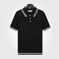 Polo en maille noir classique pour homme avec bordures rayées blanches - M / Hauts / Noir