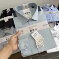Close-up view of a premium mulberry silk and modal blend formal men's shirt in light blue - 38 / Tops / Green