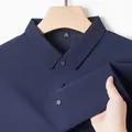 Close-up of navy blue ice silk polo shirt with breathable mesh texture and collar detail. - Navy Blue