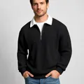 Detail showing texture of black waffle knit sweatshirt with white contrast collar and zip - Black