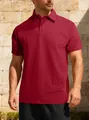 Close-up of men's burgundy jacquard polo shirt showing textured fabric detail and collar. - Burgundy