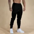 Pantaloni sportivi da uomo neri, vestibilità slim, vita elastica con coulisse e polsini a costine - Taglia S / Nero