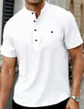 Close-up detail of a men's white linen Henley shirt featuring a stand collar and black buttons - White