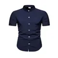 Detailed view of navy blue short sleeve shirt with white buttons and mandarin collar. - Dark Blue