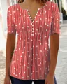 Close-up of women's red V-neck shirt with geometric white print and button detail - S / Tops / Red
