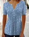 Detail of women's blue V-neck shirt featuring white geometric dot prints and button accents - S / Tops / Blue