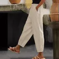 Side view of women's beige cotton linen loose casual pants with elastic waist and pockets - S / Bottoms / Apricot