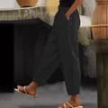 Detail view of women's black linen pants with elastic waist and side pockets - S / Bottoms / Black