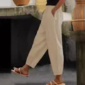 Detailed side view of beige cotton linen casual trousers with pockets and elastic waist - S / Bottoms / Khaki