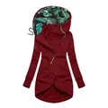 Detailed view of burgundy zip-up hoodie featuring tropical leaf print hood lining. - Burgundy