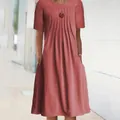 Detailed view of women's short sleeve pleated midi dress featuring pockets and round neck. - S / Tops / Red