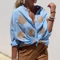 Close-up detail of women's light blue shirt with gold ethnic embroidery and buttons - S / Tops / Sky Blue