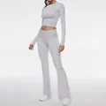Close-up view of a grey long sleeve crop top and matching flared leggings two-piece set - XS / Top And Bottom / Light Gray