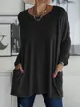Dettaglio di una tunica nera a maniche lunghe con tasche anteriori per un look casual - Taglia S / Top / Nero