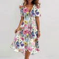 Detailed view of vibrant floral print and V-neckline on casual summer midi dress - S / Bottoms / Colorful Floral