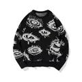 Detailed close-up of white eye jacquard knit pattern on a black oversized sweater. - M / Tops / Black and White