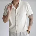 Men's textured white knitted short sleeve polo shirt with casual lapel and button closure - S / Tops / White