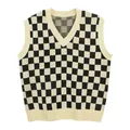 Macro view of black and white checkerboard knit sweater vest with V-neckline - Apricot Black Checkerboard