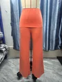 Detailed view of bright orange high-waisted wide-leg trousers on a mannequin - XS / Bottoms / Orange