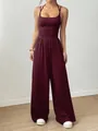 Close-up detail of a stylish burgundy halter wide-leg jumpsuit for women with a cinched waist. - XS / Top And Bottom (X8) / Burgundy