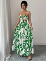 Elegant white maxi dress featuring green leaf print, spaghetti straps, and waist cut-outs - Light Green