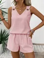 Detail view of pink striped V-neck top with metal grommets and high waist shorts - S / Top And Bottom / Pink