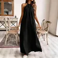 Detailansicht eines eleganten schwarzen Neckholder-Maxikleids in gemütlicher Umgebung - S / Oberteil Und Unterteil / Schwarz
