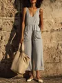 Detailed view of light blue linen V-neck jumpsuit with pockets in a summer setting - S / Top And Bottom / Light Gray