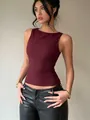 Detailed view of a slim-fit burgundy sleeveless tank top styled with black leather pants. - S / Tops / Burgundy