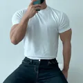 Close-up detail of white slim fit men's athletic training T-shirt with high elasticity - M / Tops / White