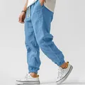 Close-up of men's blue linen jogger pants with elastic waist and breathable fabric - S / Bottoms / Light Blue