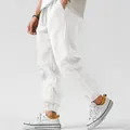 Detail view of men's white breathable linen jogger pants with elastic cuffs for summer - S / Bottoms / White