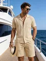 A male model wearing a casual beige linen shirt and shorts set on a yacht deck - S / Top And Bottom / Khaki