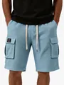 Macro view of men's light blue waffle knit cargo shorts showing texture and side pocket - S / Bottoms / Light Blue