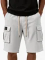 Close-up macro detail of men's light gray waffle knit cargo shorts with drawstring and pockets - S / Bottoms / White