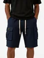 Detailed macro view of navy blue waffle texture cargo shorts for men with flap pockets - S / Bottoms / Navy Blue