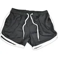 Close-up detail of breathable black mesh sports shorts featuring white trim and drawstring - M / Bottoms / Black with White Edge