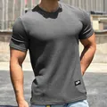 Detailed view of the men's athletic t-shirt showing the textured grey snake-skin fabric. - M / Tops / Gray