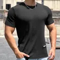 Detailed view of men's quick-dry black fitness T-shirt featuring snake-skin textured fabric - M / Tops / Black
