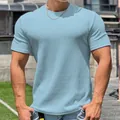 Primo piano della t-shirt fitness azzurra con trama dettagliata a pelle di serpente. - Taglia M / Top / Blu Chiaro Liscio
