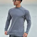 Macro view of grey thermal long sleeve shirt showing slim muscle fit on a male model - M / Tops / Blue Gray