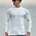 Close-up of white slim fit long sleeve sports t-shirt with muscle fit and fleece lining - M / Tops / White