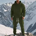 Full body view of a man in an olive green jacquard tracksuit standing on a mountain - S / Green
